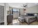 Spacious main bedroom with ceiling fan, dark wood floors, and ensuite bath at 1714 Ringe Ln, Las Vegas, NV 89156