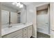 Bright bathroom featuring double sinks, marble countertop, tub, shower, and tiled flooring at 172 Petaluma Valley Dr, Las Vegas, NV 89138