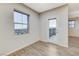 Bright bedroom with wood-look tile flooring and a door to a balcony at 172 Petaluma Valley Dr, Las Vegas, NV 89138