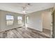 Inviting bedroom featuring plank floors, ceiling fan, neutral walls, and bright windows at 172 Petaluma Valley Dr, Las Vegas, NV 89138