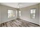 Bright, empty bedroom with plank flooring, neutral walls, ceiling fan, and many windows at 172 Petaluma Valley Dr, Las Vegas, NV 89138