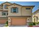 Charming two-story home with a two-car garage and tan stucco exterior at 172 Petaluma Valley Dr, Las Vegas, NV 89138