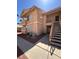 Two-story home with stucco exterior, balcony, and stairs leading to the upper level at 1830 N Pecos Rd # 155, Las Vegas, NV 89115