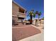View of the side of a condominium complex with desert landscaping and a gated fence at 1830 N Pecos Rd # 155, Las Vegas, NV 89115