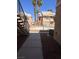 Condominium exterior view from a side angle, featuring landscaping and metal fence at 1830 N Pecos Rd # 155, Las Vegas, NV 89115