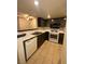A view of the kitchen with dark wood cabinets and white countertops at 1830 N Pecos Rd # 155, Las Vegas, NV 89115