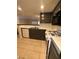 A kitchen featuring dark wood cabinets, white appliances, and a gas stove at 1830 N Pecos Rd # 155, Las Vegas, NV 89115