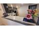 Cozy kitchen featuring sleek gray cabinetry, tile countertops and decorative flowers at 1830 N Pecos Rd # 155, Las Vegas, NV 89115