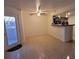 Open-concept living room and kitchen area featuring tile flooring and a ceiling fan at 1830 N Pecos Rd # 155, Las Vegas, NV 89115