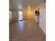 Open-concept living room with neutral tile flooring, ceiling fan, and access to the patio at 1830 N Pecos Rd # 155, Las Vegas, NV 89115