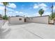 The backyard features a concrete pad with blue skies and tall palm trees at 2112 Santa Ynez Dr, Las Vegas, NV 89104