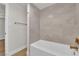 Bathroom featuring gold hardware, and gray tiled walls at 2112 Santa Ynez Dr, Las Vegas, NV 89104