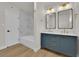 Beautifully renovated bathroom boasts double sinks, modern fixtures, and a luxurious soaking tub with tiled walls at 2112 Santa Ynez Dr, Las Vegas, NV 89104