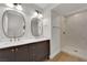 Modern bathroom featuring a double sink vanity, quartz countertops, and a tiled walk-in shower at 2112 Santa Ynez Dr, Las Vegas, NV 89104