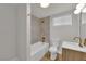 Bathroom featuring gold fixtures, white toilet, tub with tiled walls at 2112 Santa Ynez Dr, Las Vegas, NV 89104