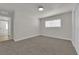 Carpeted bedroom with neutral colors, closet, and view to an adjacent room at 2112 Santa Ynez Dr, Las Vegas, NV 89104