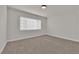 Bright carpeted bedroom featuring white trim and a window with blinds at 2112 Santa Ynez Dr, Las Vegas, NV 89104