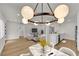 Dining area featuring a modern chandelier, marble table, and open views into the living room and kitchen at 2112 Santa Ynez Dr, Las Vegas, NV 89104