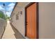 Exterior angle view of the home with a new orange door at 2112 Santa Ynez Dr, Las Vegas, NV 89104