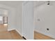 Hallway with wood flooring and white walls, leading to a laundry area at 2112 Santa Ynez Dr, Las Vegas, NV 89104