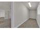 Hallway featuring neutral carpet, white wall and window at 2112 Santa Ynez Dr, Las Vegas, NV 89104