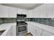 Bright kitchen features white cabinets, quartz countertops and stainless steel appliances at 2112 Santa Ynez Dr, Las Vegas, NV 89104