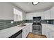 Bright kitchen features stainless steel appliances, white cabinets, quartz countertops, and stylish backsplash at 2112 Santa Ynez Dr, Las Vegas, NV 89104