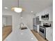 Bright, modern kitchen features stainless steel appliances, white cabinetry, and a large quartz countertop island at 2112 Santa Ynez Dr, Las Vegas, NV 89104