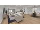 Open concept living room with modern furnishings, ample seating, and a combined dining area with modern chandelier at 2112 Santa Ynez Dr, Las Vegas, NV 89104