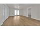 Large living room area featuring bright interiors, ceiling fan, access to back yard via french doors, and wood-look floors at 2112 Santa Ynez Dr, Las Vegas, NV 89104