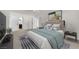 Well-lit main bedroom with a large bed, modern decor, and access to an en-suite bathroom at 2112 Santa Ynez Dr, Las Vegas, NV 89104