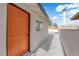 Side entrance featuring white siding, with an orange front door at 2112 Santa Ynez Dr, Las Vegas, NV 89104
