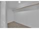 Bright, carpeted walk-in closet features ample storage with installed shelving and trim at 2112 Santa Ynez Dr, Las Vegas, NV 89104