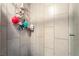 Clean tiled shower featuring modern hardware, corner shelving, and light walls at 2200 Santa Ynez Dr, Las Vegas, NV 89104