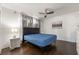 This bedroom has hardwood floors, large window, and ceiling fan at 2200 Santa Ynez Dr, Las Vegas, NV 89104