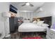 Large bedroom featuring ceiling fan, wall mounted AC unit, dark wood dresser, and tv at 2200 Santa Ynez Dr, Las Vegas, NV 89104