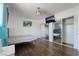 Bright bedroom with hardwood floors, mirrored closet doors, and TV at 2200 Santa Ynez Dr, Las Vegas, NV 89104