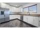 Open kitchen with white cabinets, stainless steel appliances, and stone counters at 2200 Santa Ynez Dr, Las Vegas, NV 89104