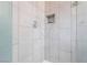 Shower with large tile surround, recessed storage, and updated fixtures at 2200 Santa Ynez Dr, Las Vegas, NV 89104