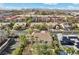 Aerial shot of neighborhood with palm-lined streets and city skyline in the distance at 253 White Willow Ave, Las Vegas, NV 89123