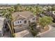 Aerial front view of a lovely two story home with a tile roof, palm trees, and desert landscaping at 253 White Willow Ave, Las Vegas, NV 89123