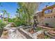 Landscaped backyard featuring a walkway, lush plants, and a decorative statue of a Personal at 253 White Willow Ave, Las Vegas, NV 89123