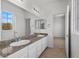 Bathroom featuring dual sinks, granite countertops, neutral walls, and modern flooring at 253 White Willow Ave, Las Vegas, NV 89123