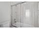 Bright bathroom featuring a tub and shower combination with clear glass sliding doors and white tile surround at 253 White Willow Ave, Las Vegas, NV 89123