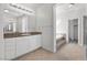 Bright bathroom featuring double sinks, granite counters, and a jacuzzi tub at 253 White Willow Ave, Las Vegas, NV 89123