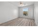 Bright bedroom featuring neutral walls, modern flooring, and a view of the outside landscape at 253 White Willow Ave, Las Vegas, NV 89123