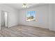 Bright bedroom featuring light wood floors, ceiling fan, and a window bringing in lots of natural light at 253 White Willow Ave, Las Vegas, NV 89123