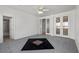 Large bedroom with gray tile flooring and a unique inlaid pattern, featuring a view to the bathroom at 253 White Willow Ave, Las Vegas, NV 89123