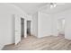 Bright bedroom featuring light wood floors, ceiling fan, with open doors and lots of natural light at 253 White Willow Ave, Las Vegas, NV 89123