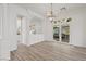 Bright dining area with wood floors, a chandelier, and french doors leading to an outdoor patio at 253 White Willow Ave, Las Vegas, NV 89123
